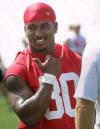 Nebraska senior I-back Dahrran Diedrick greets a teammate while talking with running backs coach Dave Gillespie before afternoon practice Saturday, Aug. 3, 2002, on the grass field adjacent Memorial Stadium in Lincoln, Neb. (AP Photo/Kelli Kellogg)