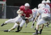 Nebraska backup quarterback Curt Dukes (7) is tackled by Adam Carriker as Dan Burrow (36) looks on during scrimmage in Lincoln, Neb., Saturday, Aug 10, 2002. The Nebraska football coaching staff got its first look at the team's progress with this first closed scrimmage. (AP Photo/Nati Harnik)