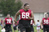 Nebraska offensive tackle Dan Vili Waldrop (68), smiles during practice Monday, Aug. 5, 2002, in Lincoln, Neb., with  Mike Erickson (78), and Gary Pike (56) behind him. With veteran tackle Dave Volk and guard John Rutherford gone, seniors Garrison and  Waldrop will lead a young group of offensive linemen into the new season. (AP Photo/Nati Harnik)